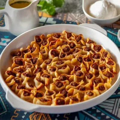 Oven-baked manti in a white dish